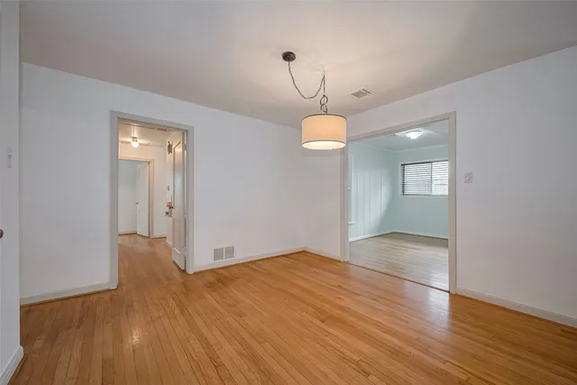 a view of an empty room and wooden floor