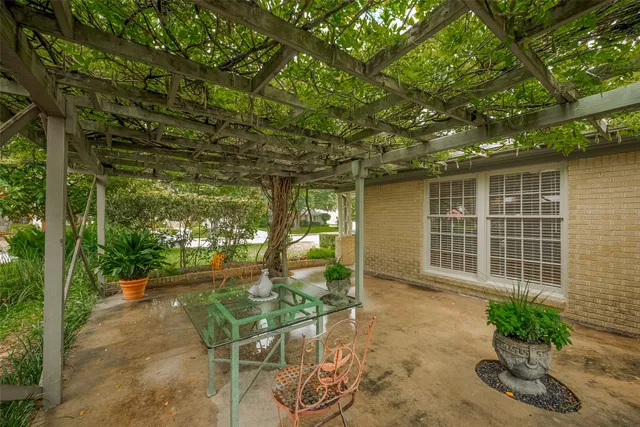 a backyard of a house with table and chairs