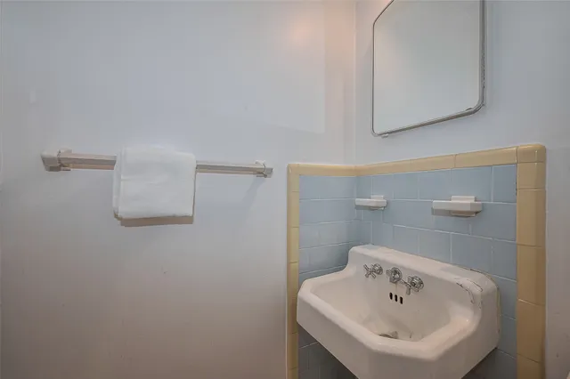 a bathroom with a sink a mirror and vanity