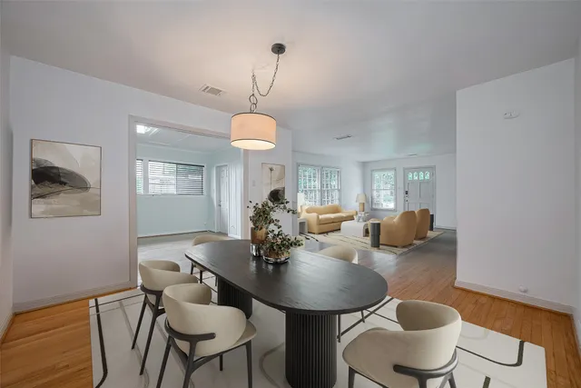 a view of a dining room with furniture and chandelier