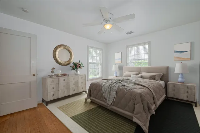 a bedroom with a bed a mirror and a window