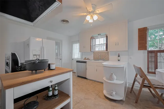 a room with a table chairs and projector