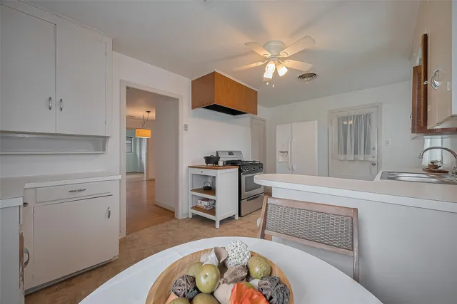 a kitchen with a stove a sink and a refrigerator