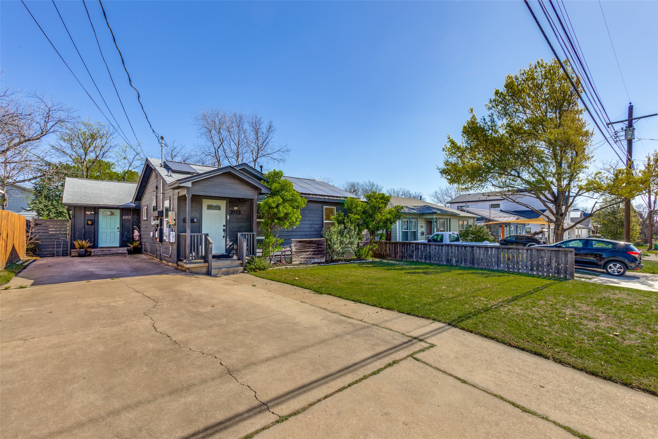 2012 Payne Avenue, Unit A Austin, TX 78757 - Photo 4 of 35 View of front of home with roof mounted solar panels, driveway, and a porch