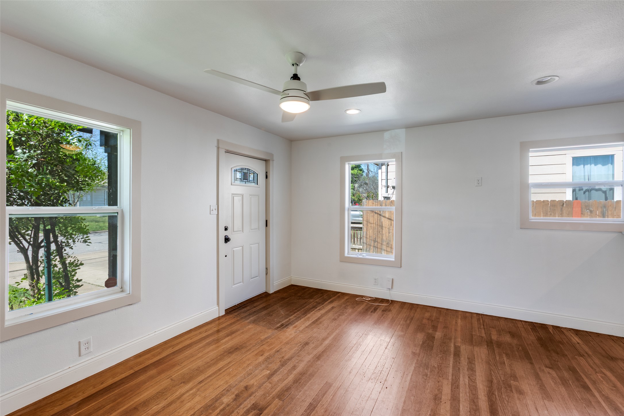 2012 Payne Avenue, Unit A Austin, TX 78757 - Photo 7 of 35 a view of an empty room with wooden floor and a window