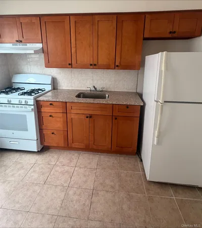 a kitchen with stainless steel appliances granite countertop a refrigerator sink and cabinets