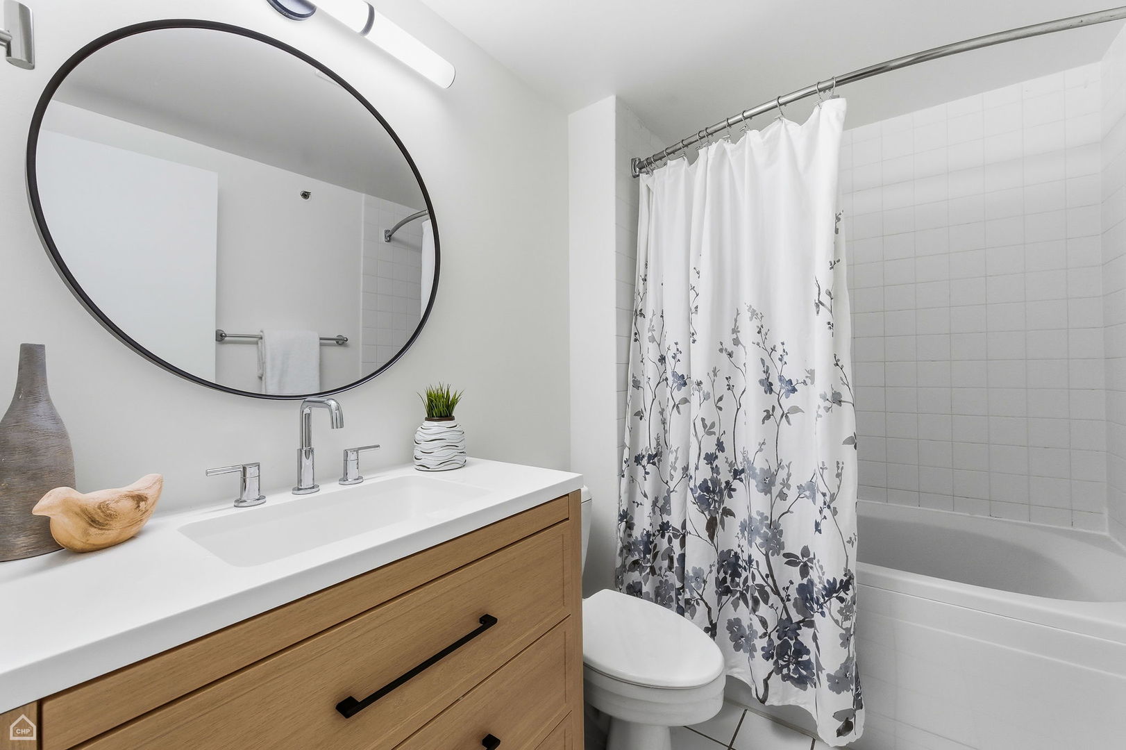 550 West Harrison Street, Unit 552 Chicago, IL 60607 - Photo 12 of 15 a bathroom with a sink a toilet and a mirror