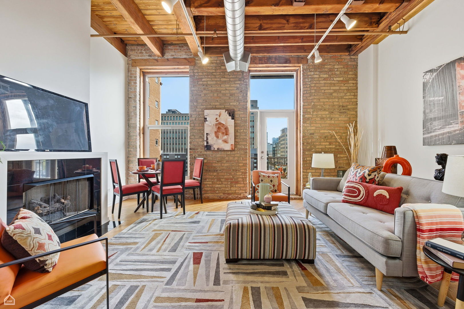 550 West Harrison Street, Unit 552 Chicago, IL 60607 - Photo 6 of 15 a living room with furniture a fireplace and a table