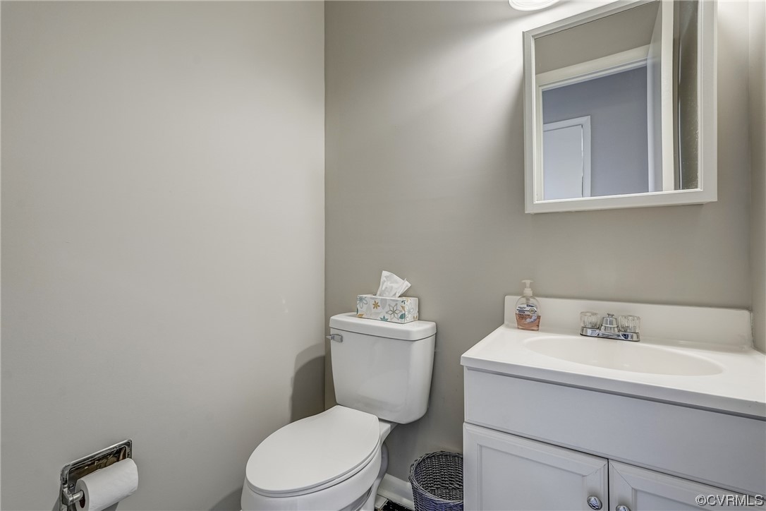 11805 South Briar Patch Drive Midlothian, VA 23113 - Photo 14 of 35 a bathroom with a toilet sink vanity and mirror