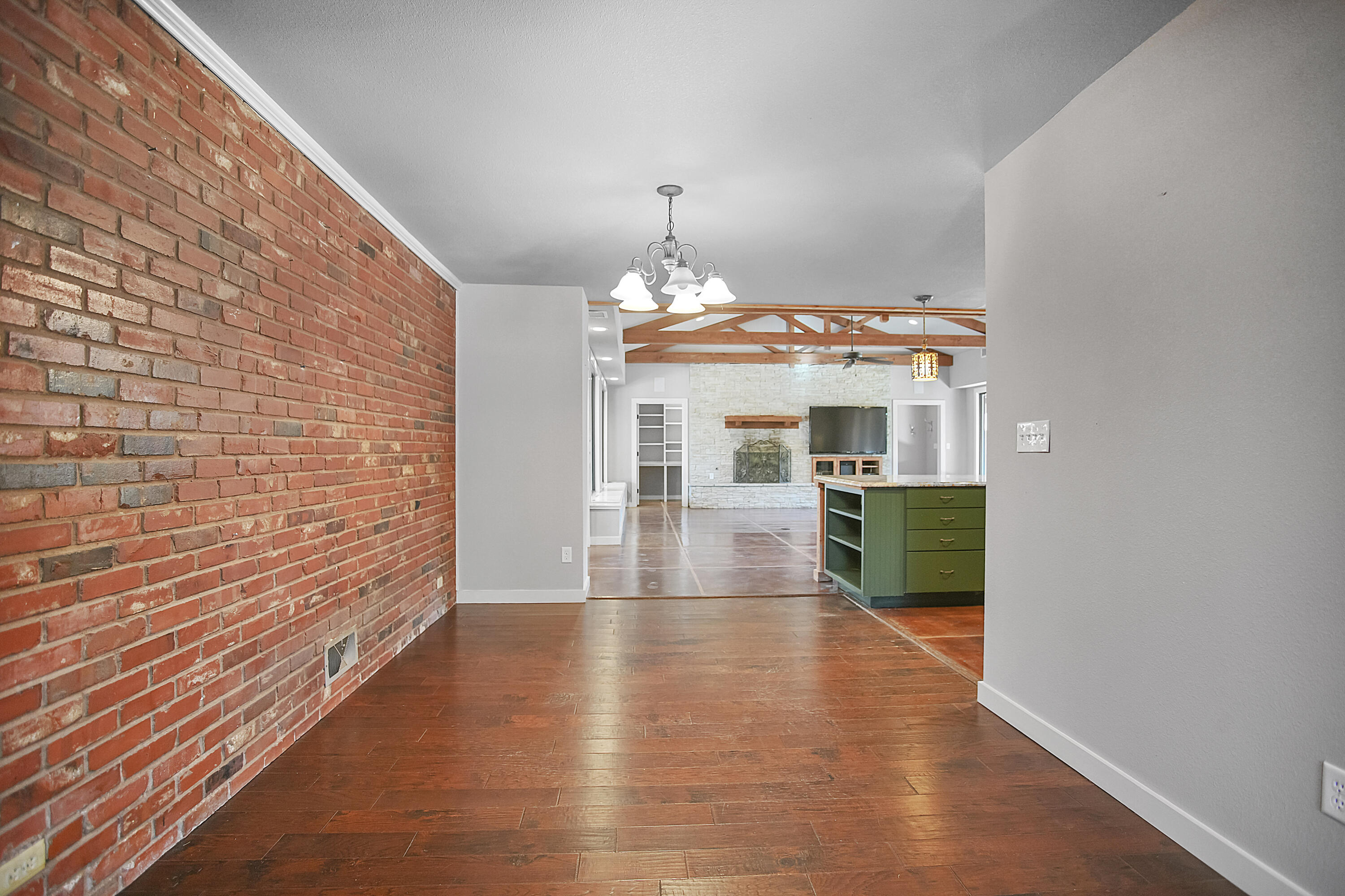 5412 20th Street Lubbock, TX 79407 - Photo 11 of 83 a view of a hallway with wooden floor and a fireplace
