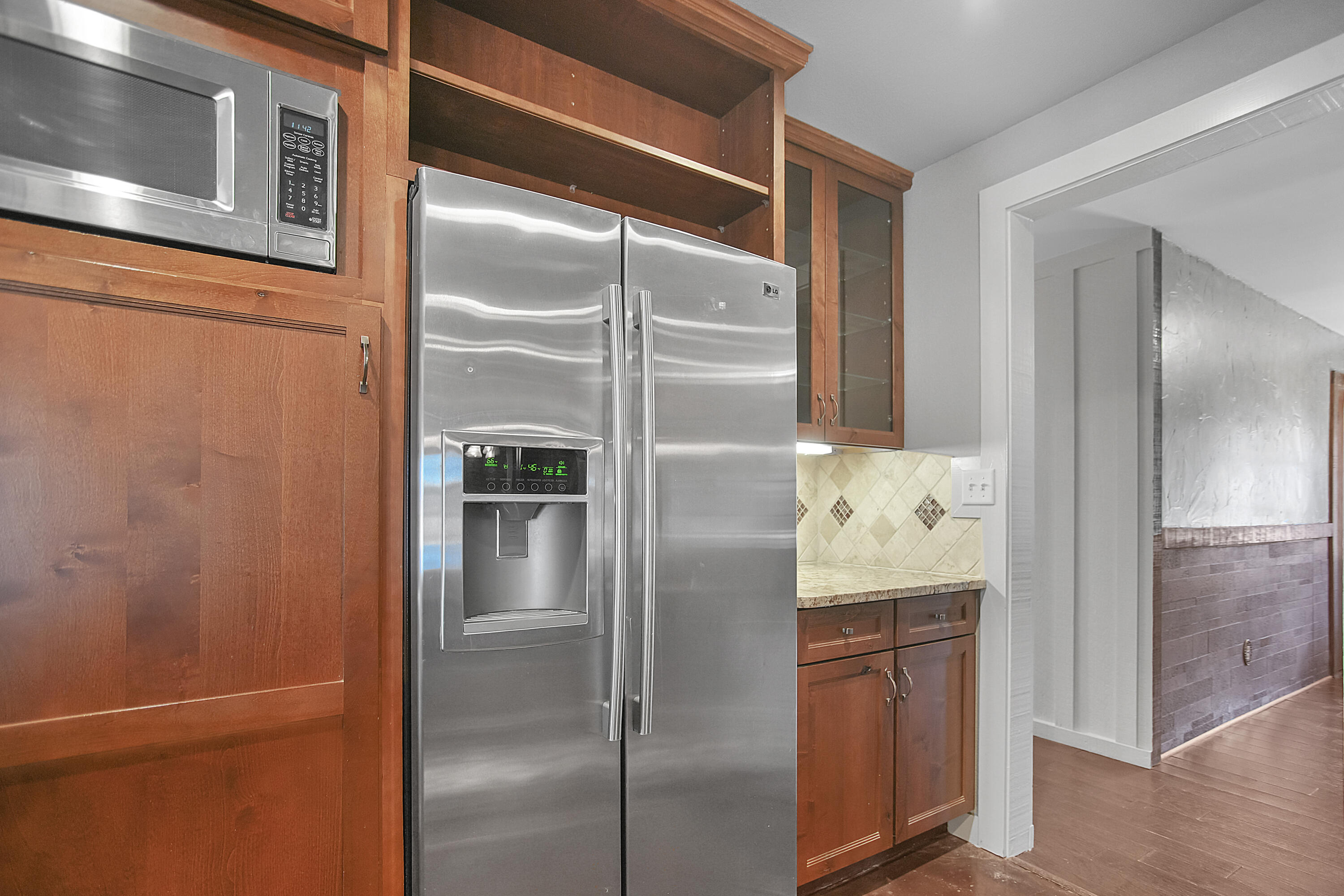 5412 20th Street Lubbock, TX 79407 - Photo 27 of 83 a kitchen with a refrigerator and wooden cabinets