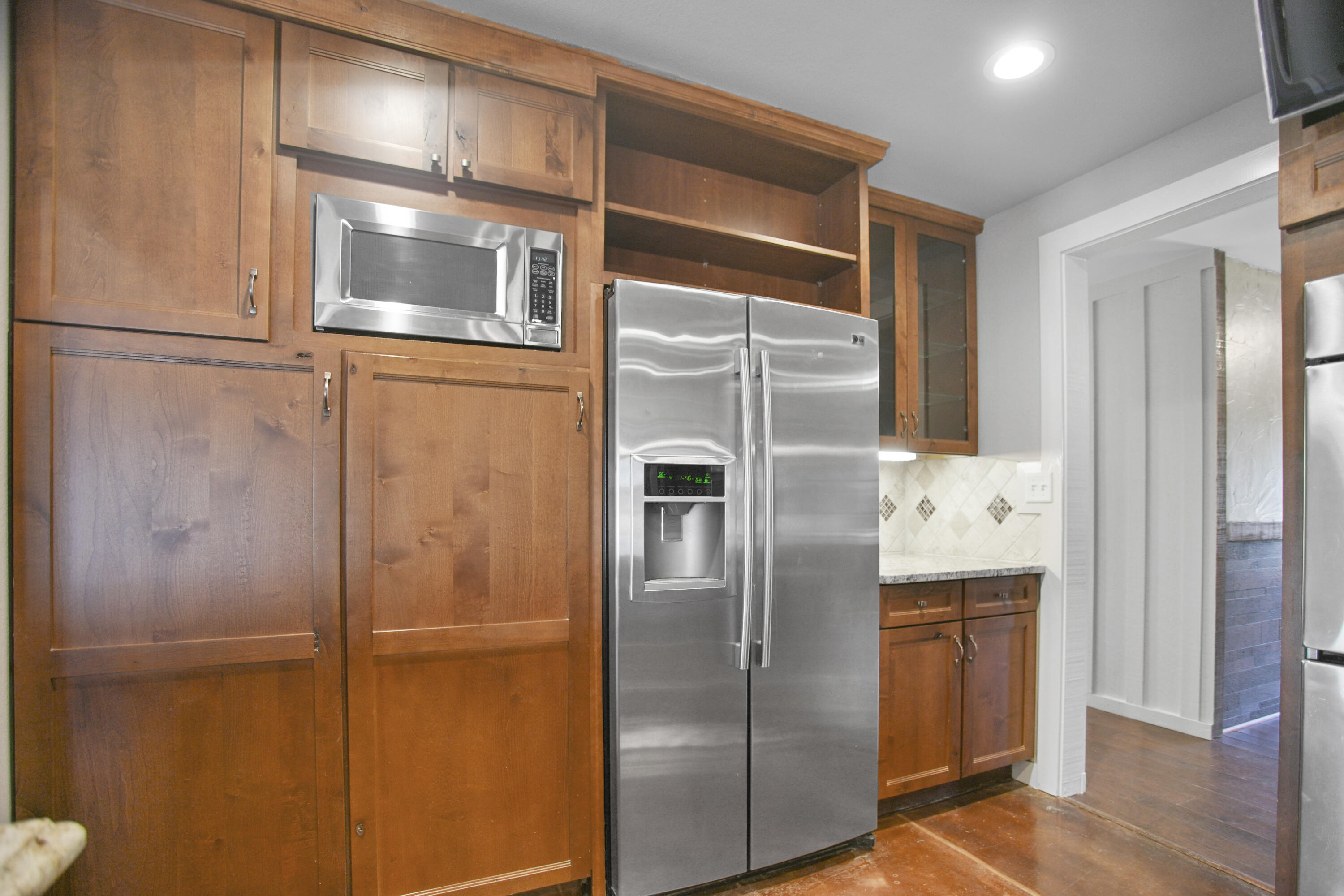 5412 20th Street Lubbock, TX 79407 - Photo 28 of 83 a kitchen with metallic refrigerator freezer and a dishwasher