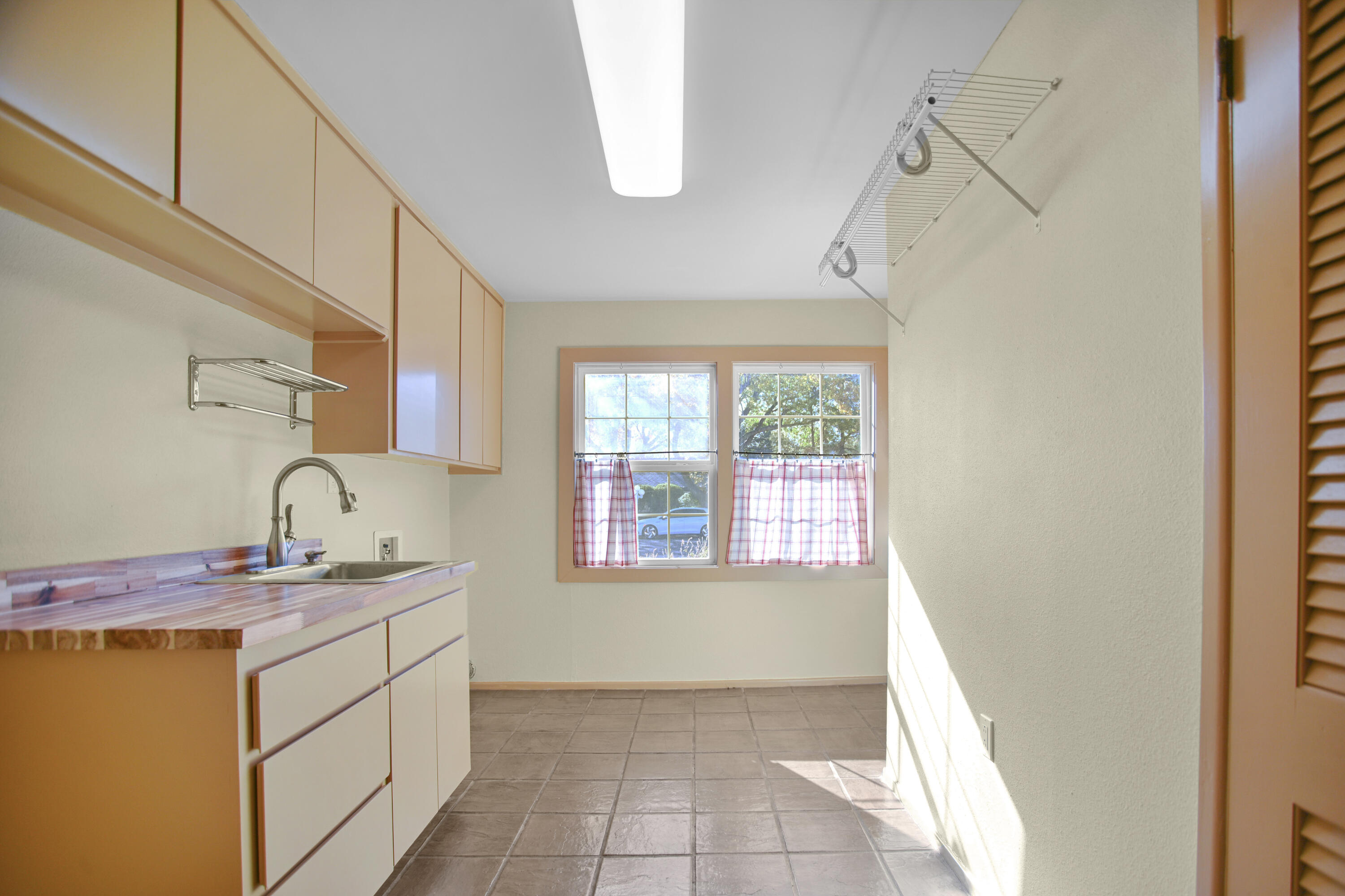 5412 20th Street Lubbock, TX 79407 - Photo 39 of 83 a utility room with cabinets washer and dryer