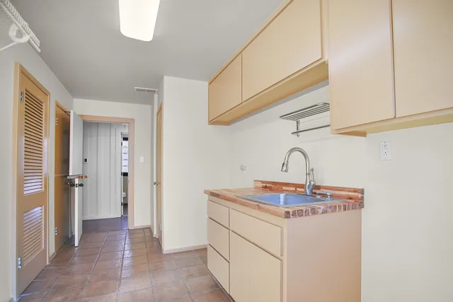 a bathroom with a granite countertop toilet a sink and a mirror