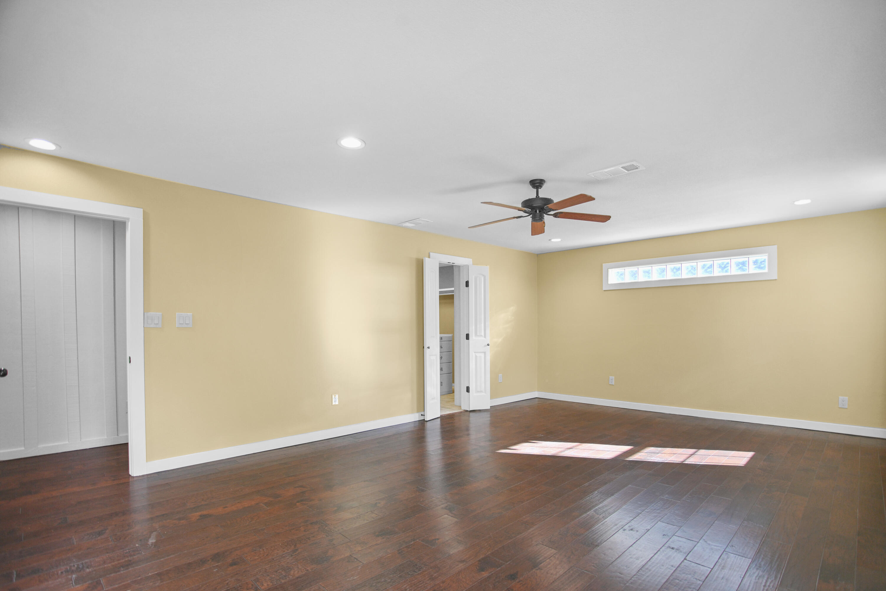 5412 20th Street Lubbock, TX 79407 - Photo 46 of 83 an empty room with wooden floor chandelier fan and windows