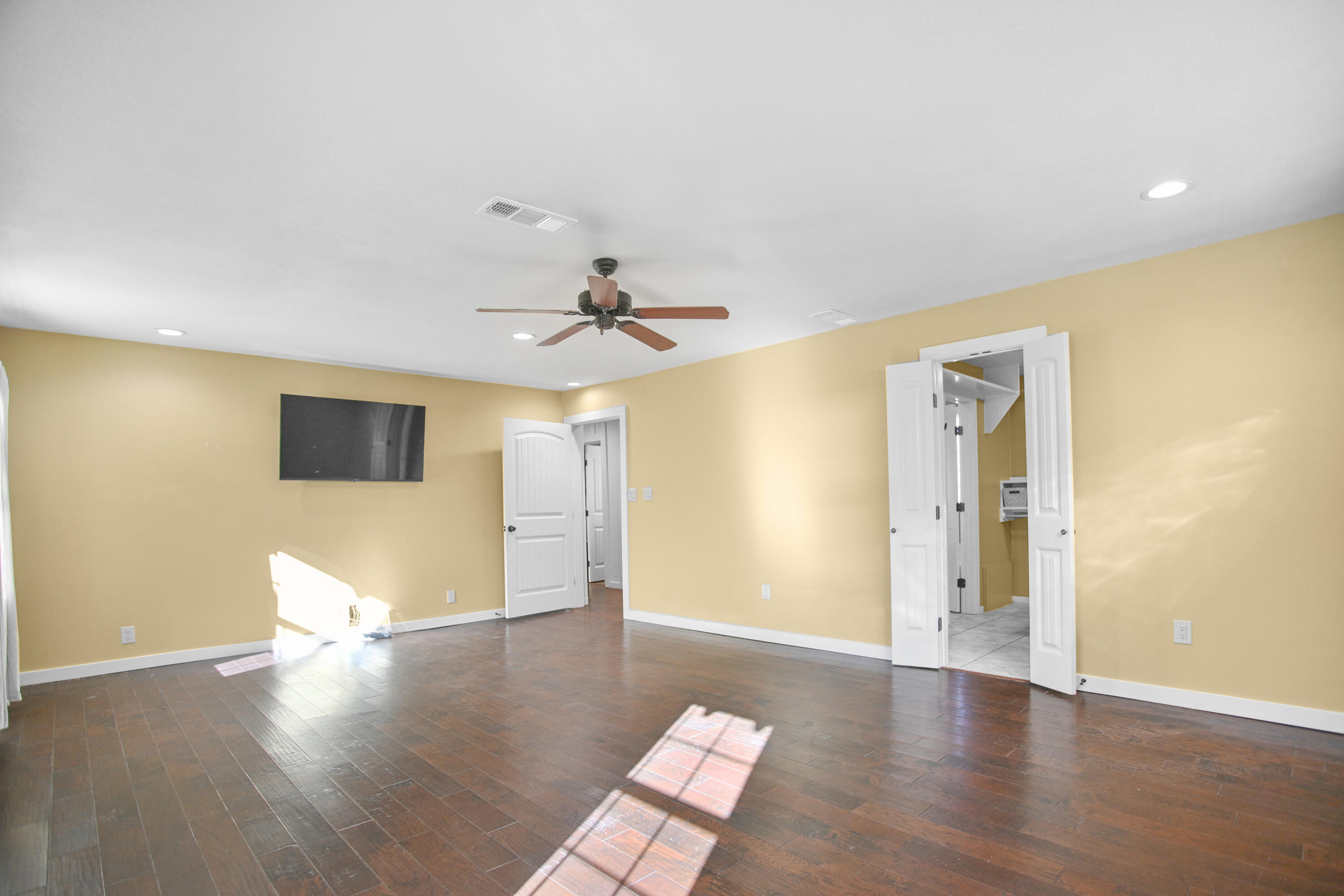 5412 20th Street Lubbock, TX 79407 - Photo 47 of 83 a view of a livingroom with wooden floor and a ceiling fan