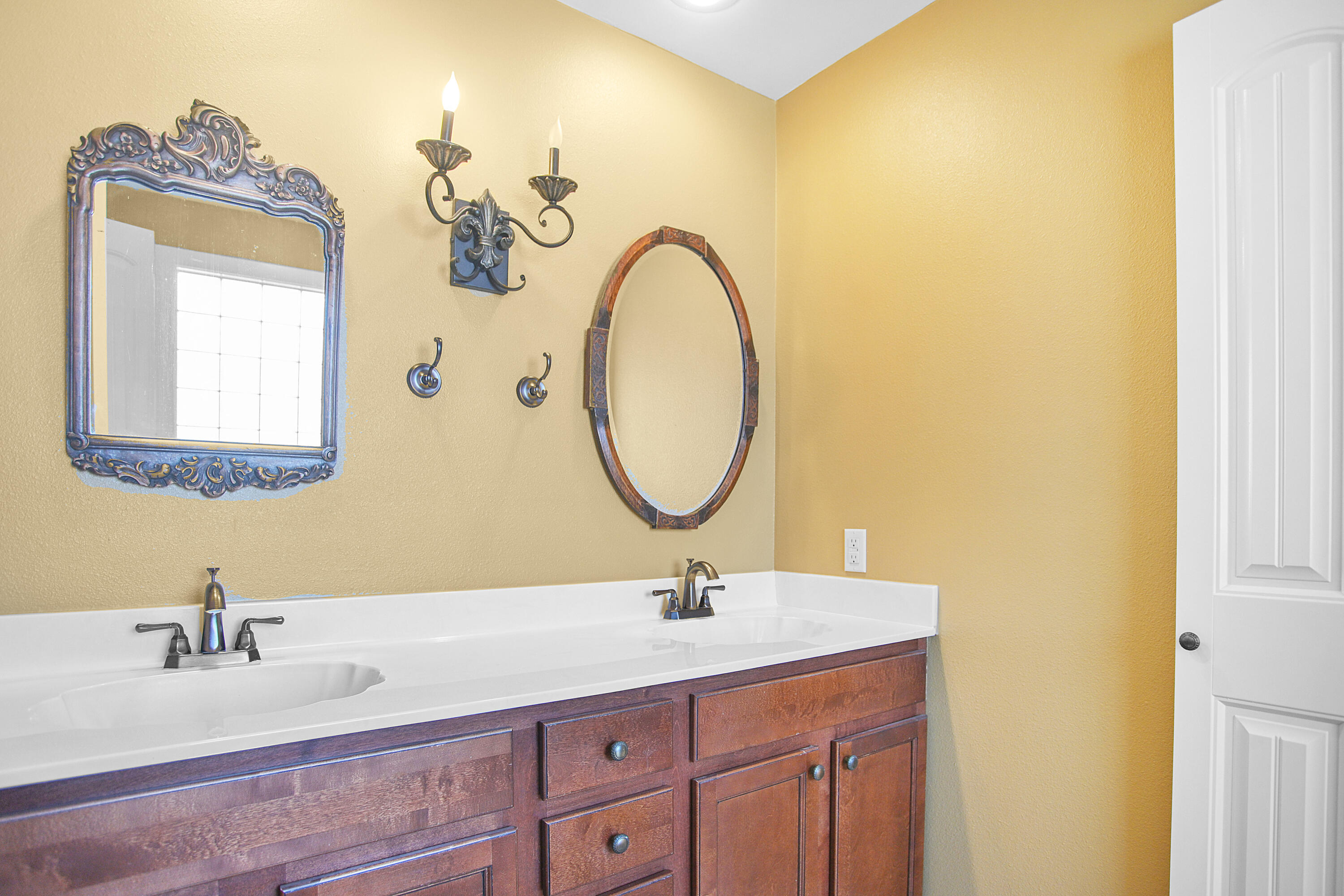 5412 20th Street Lubbock, TX 79407 - Photo 50 of 83 a bathroom with a granite countertop sink a mirror and a vanity