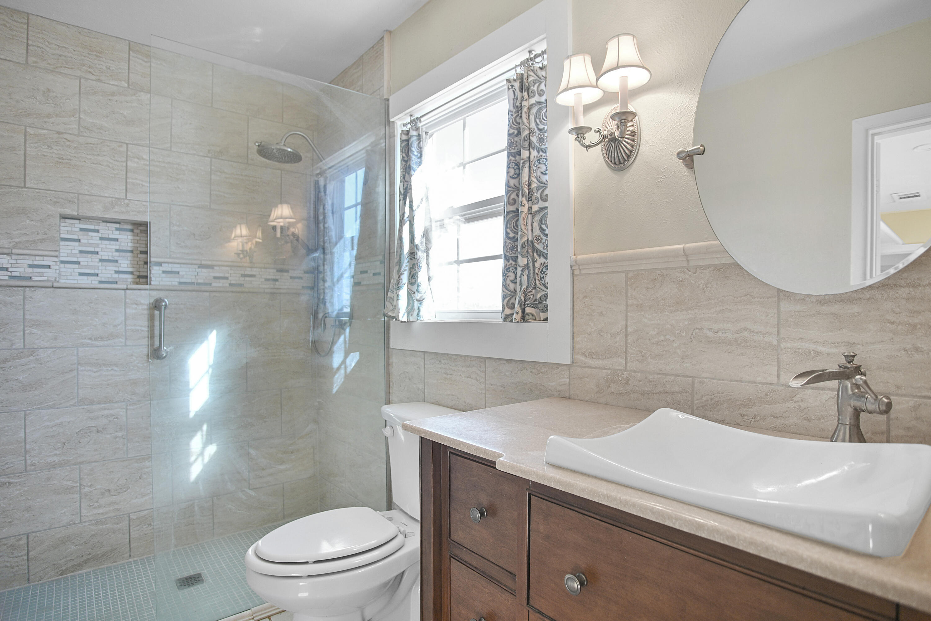 5412 20th Street Lubbock, TX 79407 - Photo 59 of 83 a bathroom with a sink a toilet and a mirror