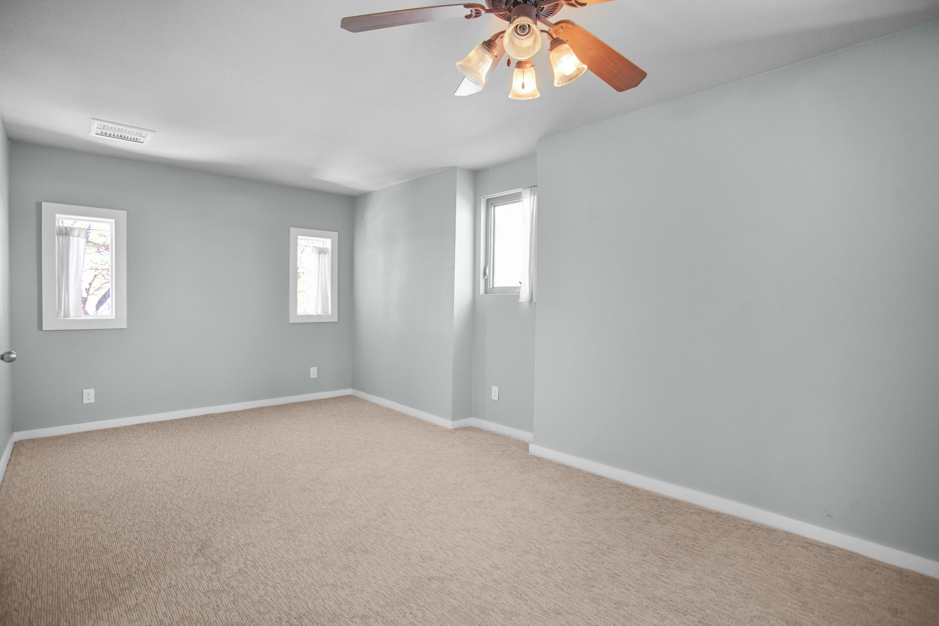 5412 20th Street Lubbock, TX 79407 - Photo 64 of 83 an empty room with windows and chandelier fan