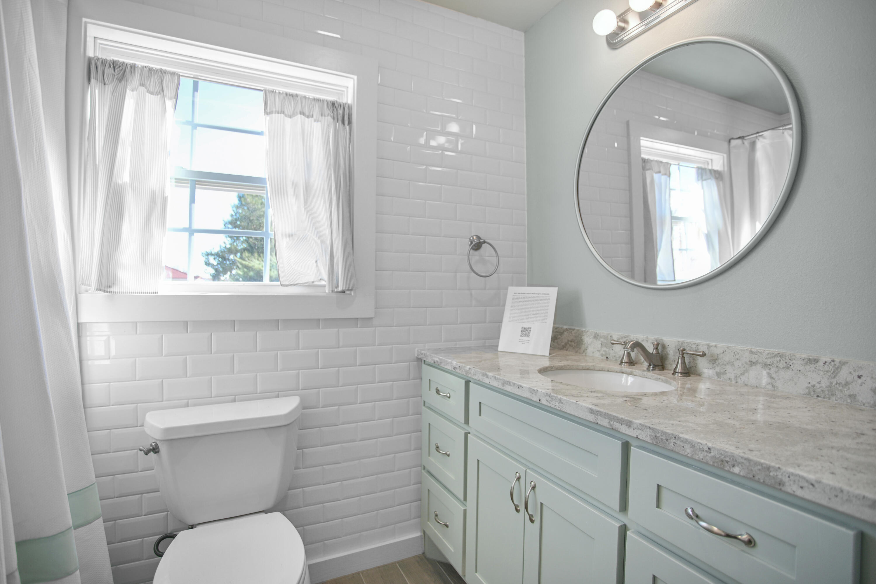 5412 20th Street Lubbock, TX 79407 - Photo 71 of 83 a bathroom with a granite countertop toilet a sink and a mirror