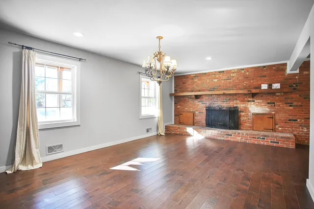 a large kitchen with stainless steel appliances granite countertop a large counter top a stove and a refrigerator