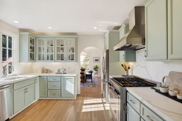 a living room with furniture and a potted plant on table