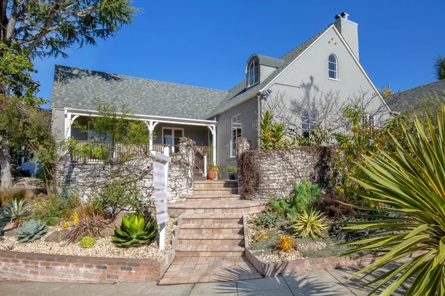 a front view of a house with garden