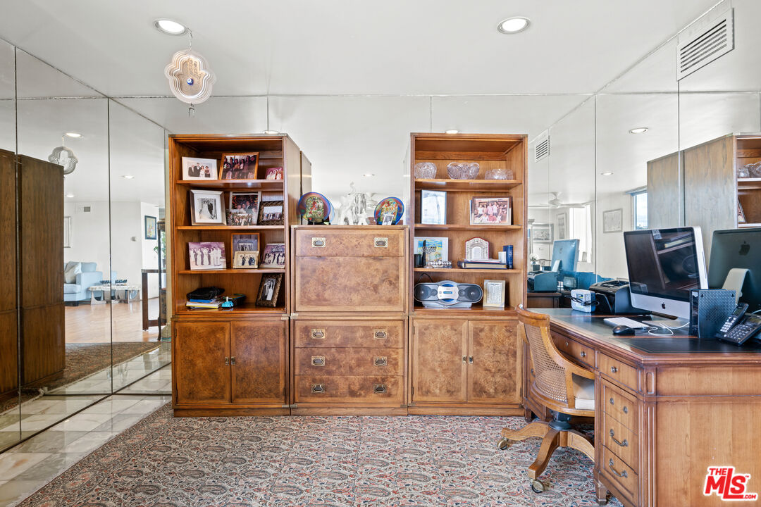 100 South Doheny Drive, Unit 512 Los Angeles, CA 90048 - Photo 13 of 37 a room with furniture and a book shelf