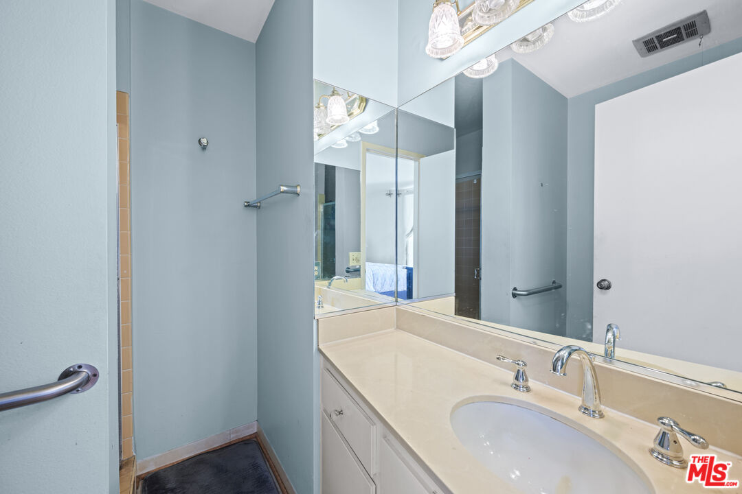 100 South Doheny Drive, Unit 512 Los Angeles, CA 90048 - Photo 25 of 37 a bathroom with a sink and a mirror