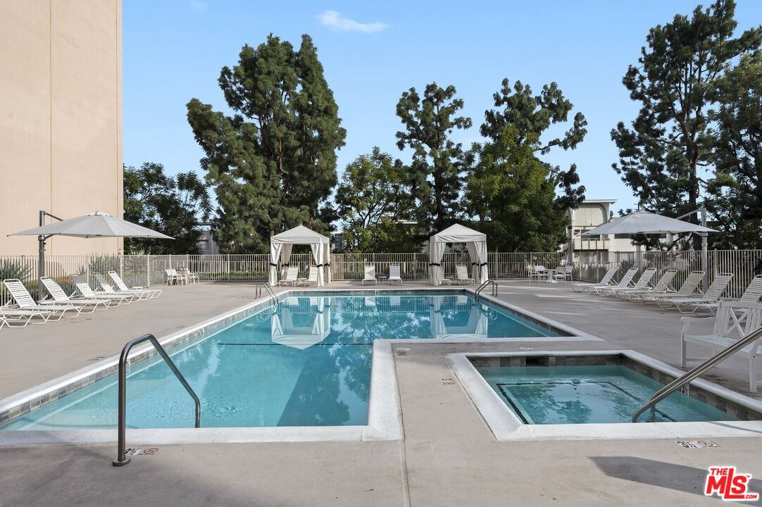 100 South Doheny Drive, Unit 512 Los Angeles, CA 90048 - Photo 31 of 37 a view of a swimming pool with a yard