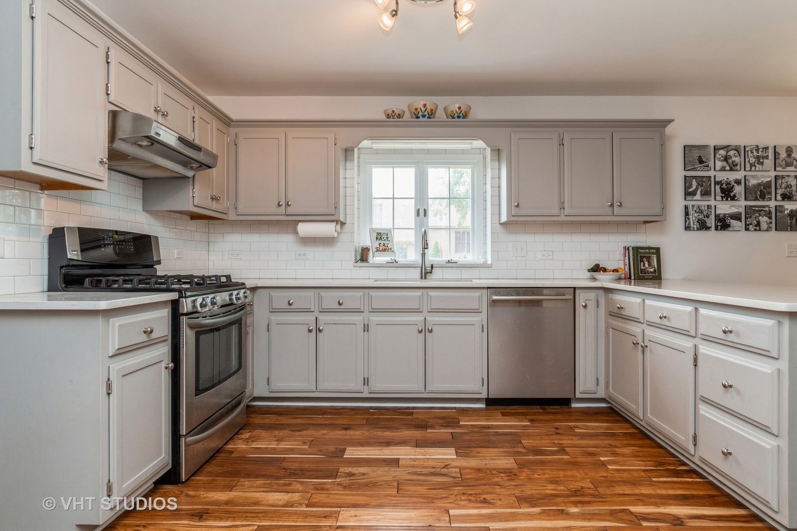 565 Boardman Circle Bolingbrook, IL 60440 - Photo 4 of 24 a kitchen with stainless steel appliances granite countertop a sink a stove a microwave and cabinets