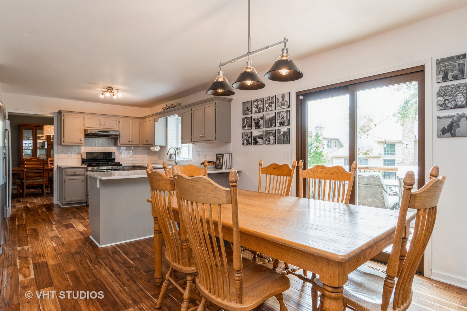 565 Boardman Circle Bolingbrook, IL 60440 - Photo 6 of 24 a view of a dining room with furniture a chandelier and wooden floor