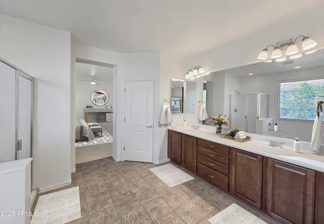 a spacious bathroom with a sink mirror and vanity