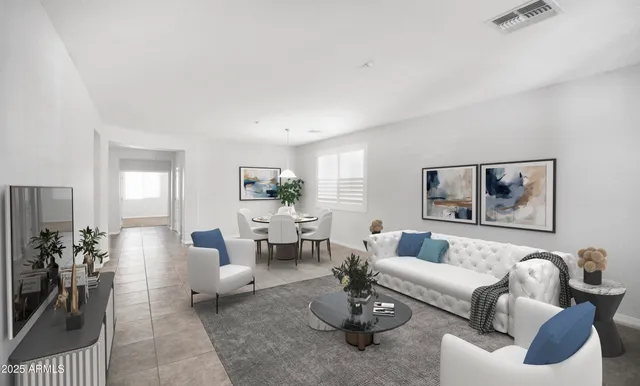 a living room with furniture potted plant and kitchen view