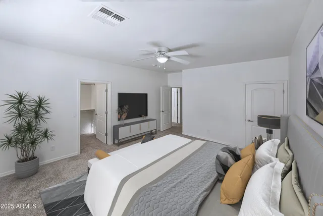 a bedroom with a bed and a television