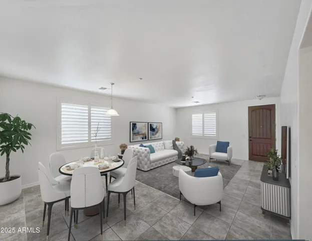 a living room with furniture and a potted plant
