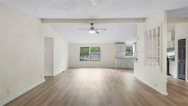 wooden floor in an empty room with a window