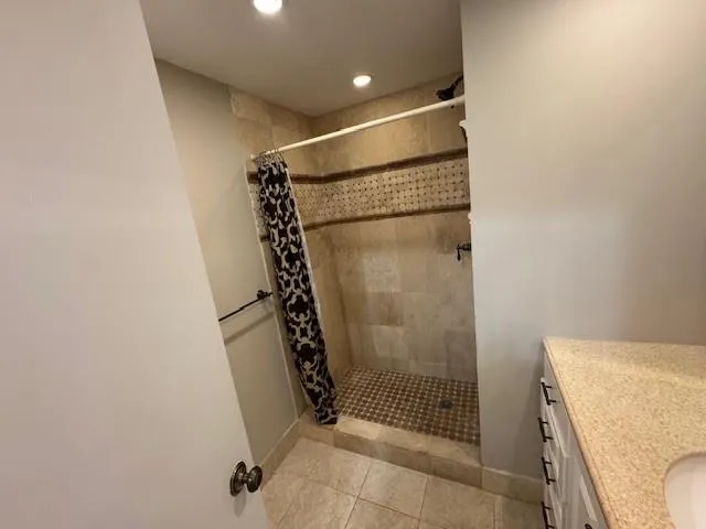 a bathroom with a shower and a sink