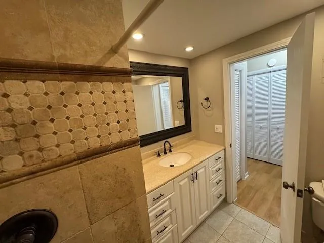 a bathroom with a double vanity sink a mirror and a shower