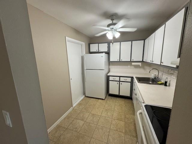 620 Northwest 13th Street, Unit 37 Boca Raton, FL 33486 - Photo 6 of 17 a kitchen with a refrigerator a sink and cabinets