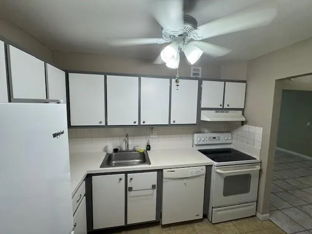 a kitchen with stainless steel appliances a sink stove and cabinets