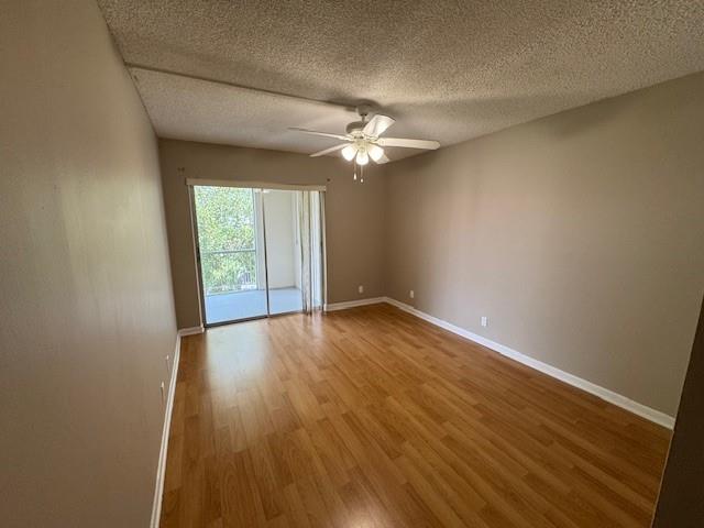 620 Northwest 13th Street, Unit 37 Boca Raton, FL 33486 - Photo 10 of 17 an empty room with wooden floor and windows
