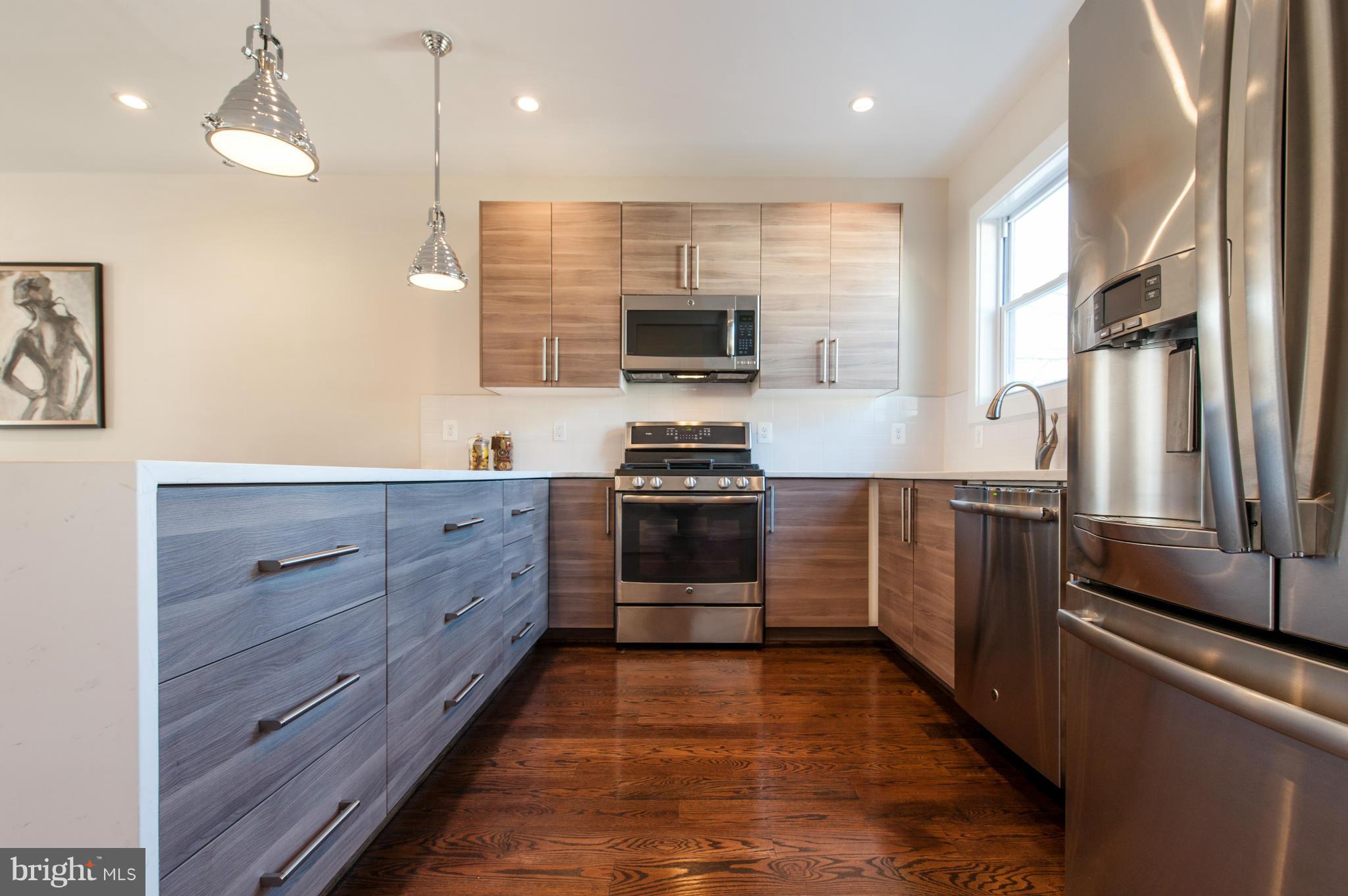1608 Potomac Avenue Southeast Washington, DC 20003 - Photo 7 of 29 a kitchen with granite countertop a refrigerator and a stove