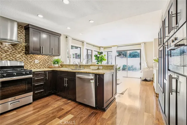 a kitchen with stainless steel appliances granite countertop a stove and a sink