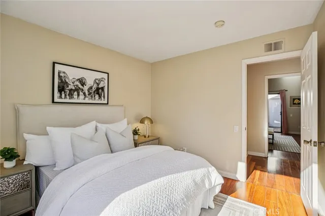 a bedroom with a bed and a painting on the wall