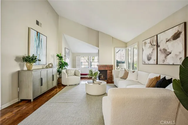 a living room with furniture and a potted plant
