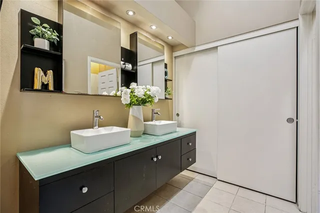 a bathroom with a double vanity sink and a mirror