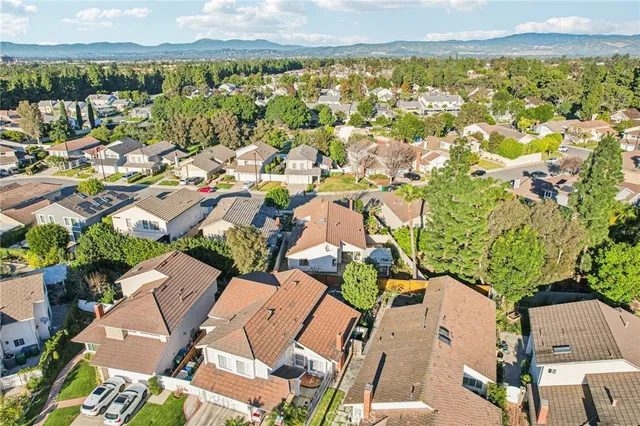 an aerial view of residential building with parking