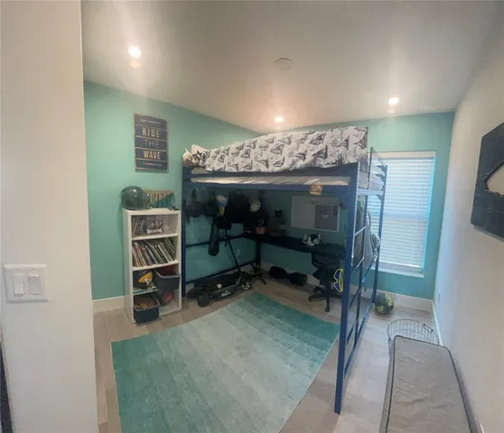 a room with furniture a ceiling fan and a rug