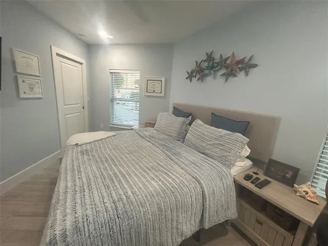 a bedroom with a bed and a painting on the wall